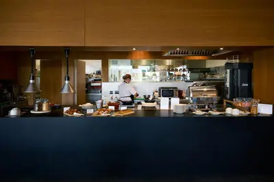 a man standing in a kitchen preparing food at La Galiana Golf Resort - Adults Only in Barraca de Aguas Vivas