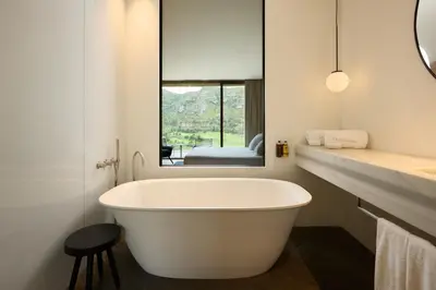 a white bath tub in a bathroom with a window at La Galiana Golf Resort - Adults Only in Barraca de Aguas Vivas