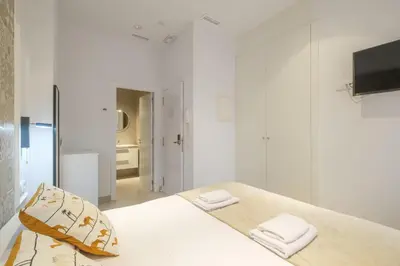 a white room with a bed and a tv at Comfortable Room close to City Centre in Valencia