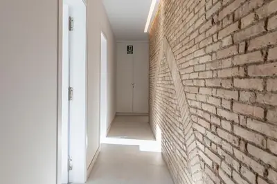 an empty hallway with a brick wall at Comfortable Room close to City Centre in Valencia