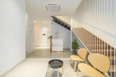 a staircase in a room with chairs and a table at Comfortable Room close to City Centre in Valencia