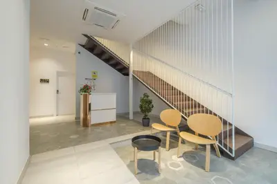 a room with a table and chairs and a staircase at Comfortable Room close to City Centre in Valencia
