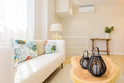 a living room with a white couch and a table at MD Reina Cabañal Beach in Valencia