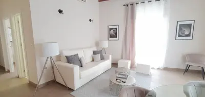 a white living room with a white couch and a table at Balmes Street in Valencia