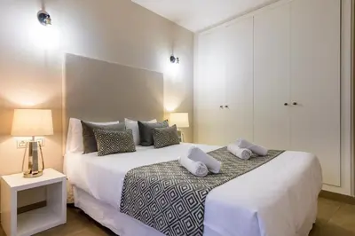 a bedroom with a large bed with two pillows on it at Balmes Street in Valencia
