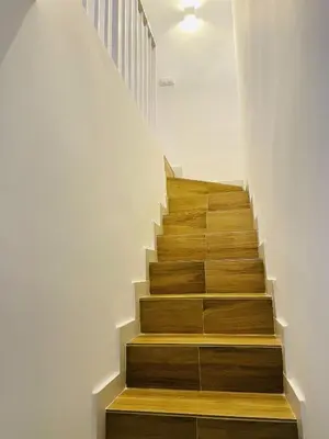 a staircase with wooden treads in a house at Torbellino de Colores in Benaguacil