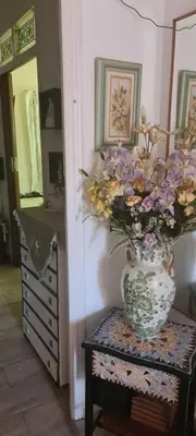 a vase with flowers on a table in a room at VALENCIA in Valencia