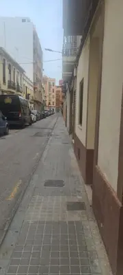 an empty street in a city with buildings at VALENCIA in Valencia