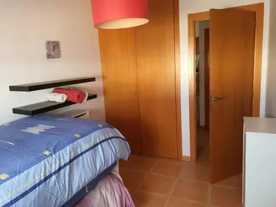a bedroom with a bed and a wooden cabinet at Apartamento Almenara Nova Almenareta in Almenara