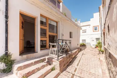 a building with a table outside of a window at La Casa Baja in Sagunto