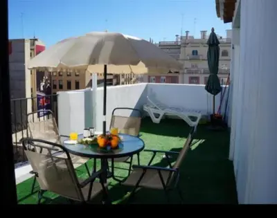 a patio with a wooden pergola and a table and chairs at Apartamento Ático en el Centro -Torres Quart in Valencia