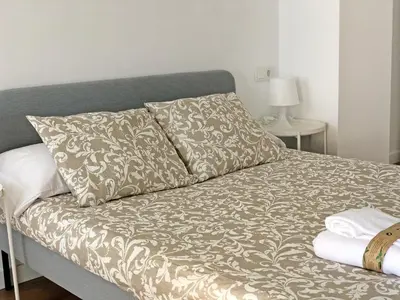 a bed with two pillows on it in a room at Global Vacacional, Increíble apartamento con vistas al mar, Canet d'en Berenguer in Canet de Berenguer