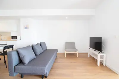 a living room with a couch and a tv at Global Vacacional, Increíble apartamento con vistas al mar, Canet d'en Berenguer in Canet de Berenguer