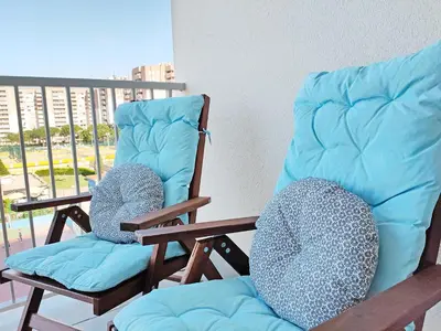 two rocking chairs sitting on top of a balcony at Global Vacacional, Apartamento nuevo en la playa de Canet d'en Berenguer in Canet de Berenguer