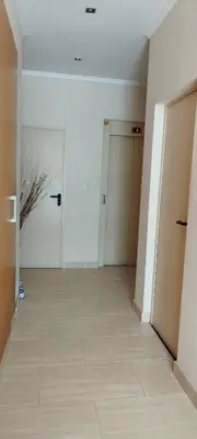 an empty room with two doors and a tile floor at Cozy Apartment close to the beach in beatiful area in El Perelló
