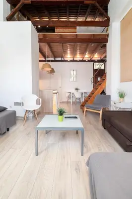 a living room with a table and a couch at Barón Suites Ruzafa in Valencia