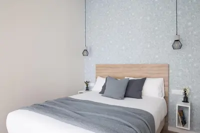a bedroom with a large white bed with pillows at FLORIT FLATS - The Maritim Serreria Suites in Valencia