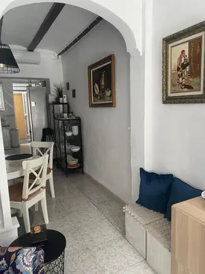 a living room with a couch and a table at Holiday House - Casa de Sylvia in Cullera