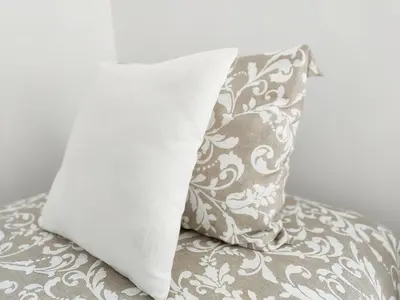 a pillow sitting on top of a bed with a pillowcase at Global Vacacional, Moderno apartamento con terraza y vistas al mar in Canet de Berenguer