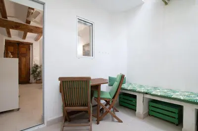 a dining room with a table and two chairs at Cabanyal old fisherman's house in Valencia
