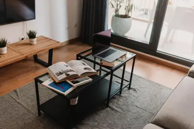 a living room with a coffee table with a laptop on it at Patacona Beach Apartment in Alboraya