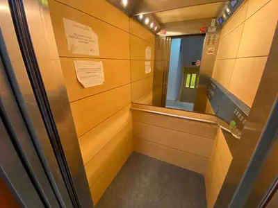 a elevator in a locker room with a mirror at Florazar 2 Cullera in Cullera