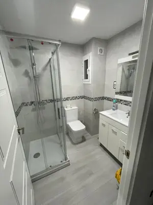 a bathroom with a shower and a toilet and a sink at Precioso apartamento de lujo en cullera in Cullera