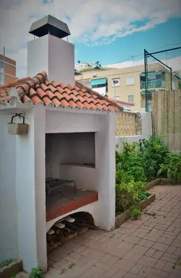 an outdoor pizza oven with a roof at CHALET VILLA Los HIPOCAMPOS in Cullera