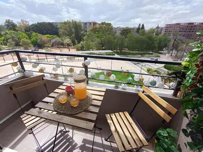a table with two glasses of orange juice on a balcony at Luxotica Gardens Valencia in Valencia