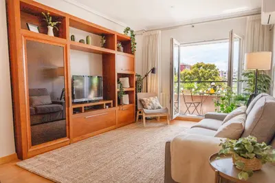 a living room with a couch and a tv at Luxotica Gardens Valencia in Valencia