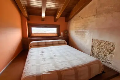 a small bedroom with a bed and a window at Casa Lucía in Requena