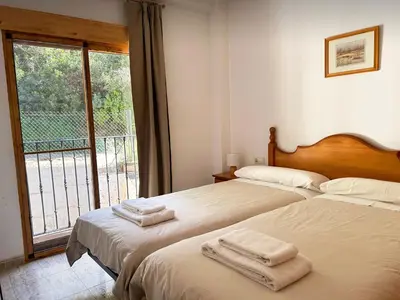 a bedroom with two beds with towels on them at Apartamentos La Muela - Chulilla in Chulilla