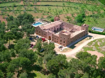 an aerial view of a large brick building with a pool at MASÍA de SAN JUAN CASA NÚMERO 15 en Castillo con piscina, Aire Acondicionado y terraza privada in Segorbe