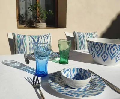 a table with blue and white plates and a bowl at MASÍA de SAN JUAN CASA NÚMERO 1 en Castillo con piscina y Aire Acondicionado in Segorbe