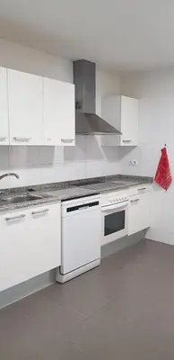 a white kitchen with white cabinets and a red bag at Apartamento C2 1Dormitorio in Lliria