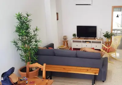 a living room with a blue couch and a tv at Apartamento C2 1Dormitorio in Lliria