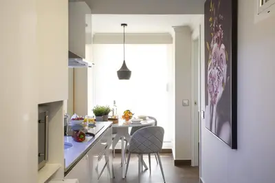 a kitchen with a table and chairs in a room at SingularStays Xativa III in Valencia