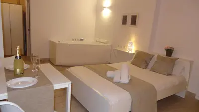 a bedroom with a bed and a bathroom with a sink at Cozy Rooms - BAÑERA HIDROMASAJE in Valencia