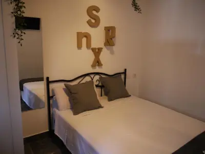 a bedroom with a bed with a sign on the wall at Cozy Rooms - BAÑERA HIDROMASAJE in Valencia