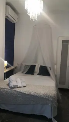 a bedroom with a white bed with a canopy at Cozy Rooms - BAÑERA HIDROMASAJE in Valencia