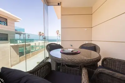 a dining room with a table and chairs and a large window at Reinapart Patacona Beach 46 in Valencia