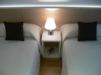 two beds in a room with a lamp between them at Center City Flats in Valencia
