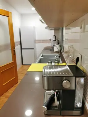 a kitchen with a coffee machine on a counter at Precioso y gran apartamento en Cullera in Cullera