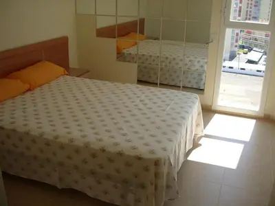 a bedroom with a bed and a large window at MAGNIFICO ATICO-DUPLEX FRENTE AL MAR in El Puig