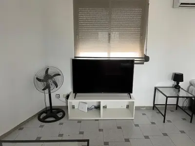 a living room with a flat screen tv and a fan at Attic Loft Gran Vía in Valencia