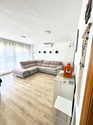 a living room with a couch and a table at Apartamento Ciudamar in Puerto de Sagunto