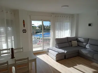 a living room with a couch and a table at Apartamento Ciudamar in Puerto de Sagunto