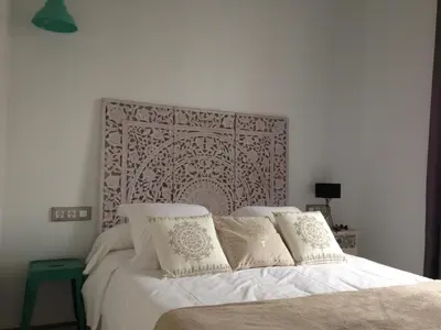 a bedroom with a bed with white sheets and pillows at El 16 Ruzafa in Valencia