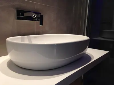 a white bowl sink on a counter in a bathroom at El 16 Ruzafa in Valencia
