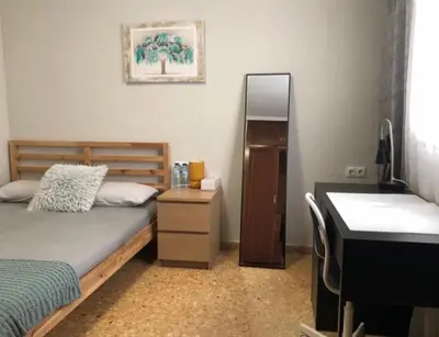 a bedroom with a bed and a sink and a mirror at Rooms near the Beach Cabanyal and Universities in Valencia
